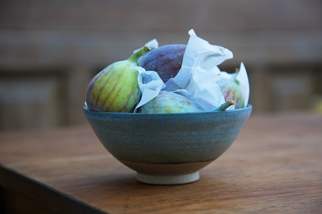 Fresh figs in a bowl on a garden table