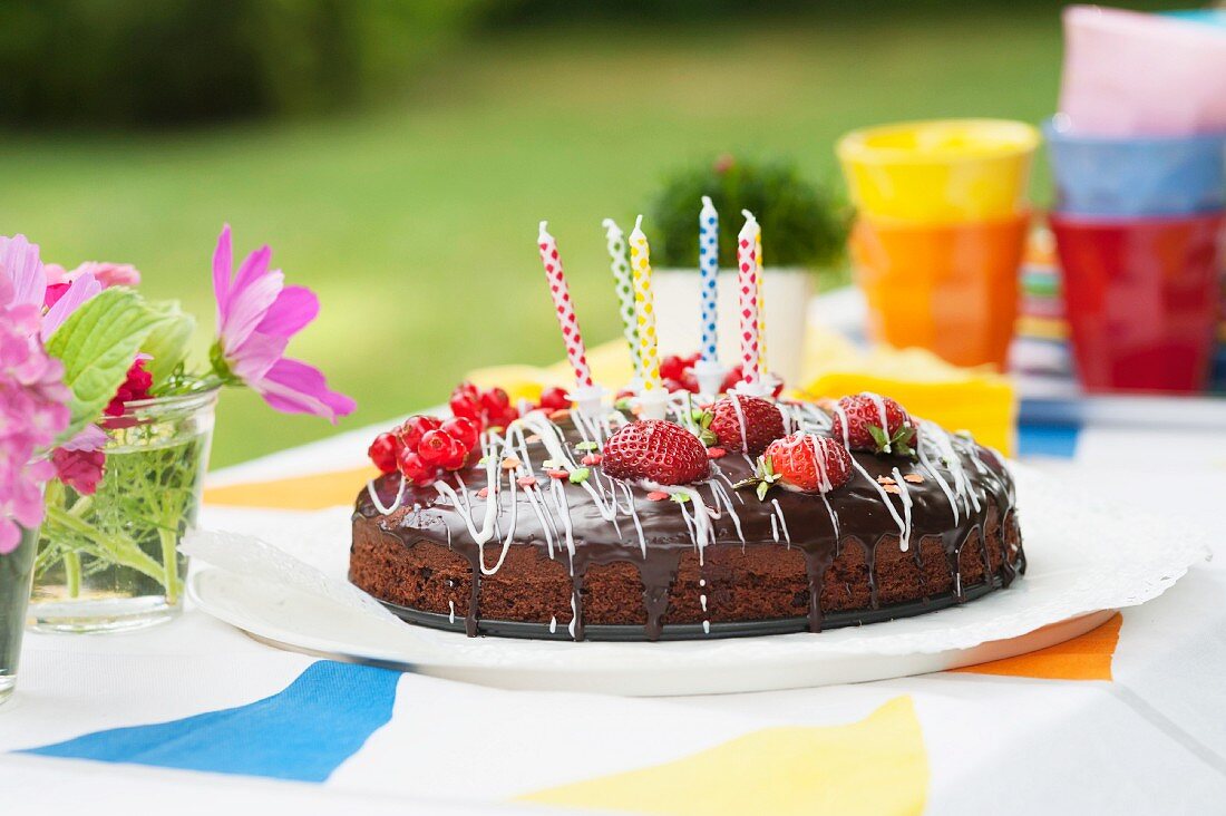 A birthday cake on a garden table