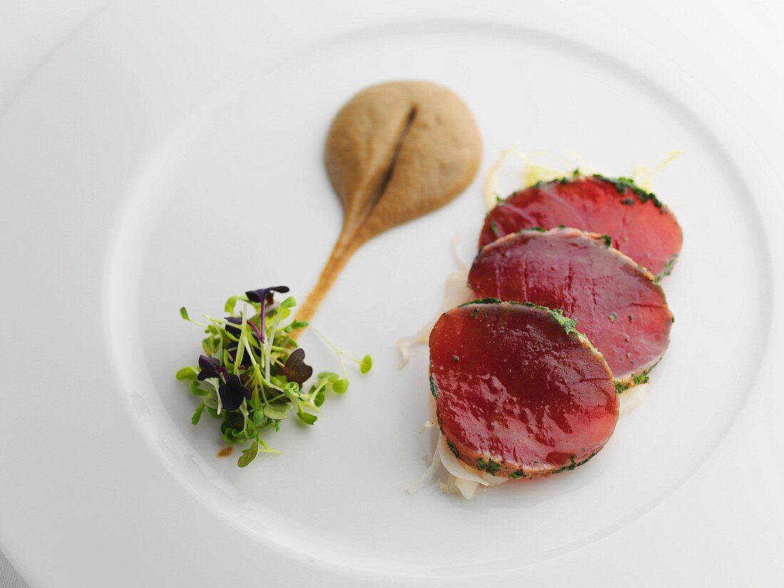 Slices of tuna with mustard and cress