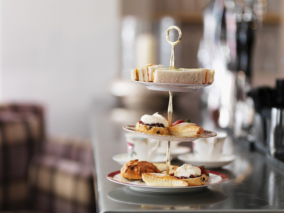 Sandwiches, cakes and pastries on a cake stand for afternoon tea
