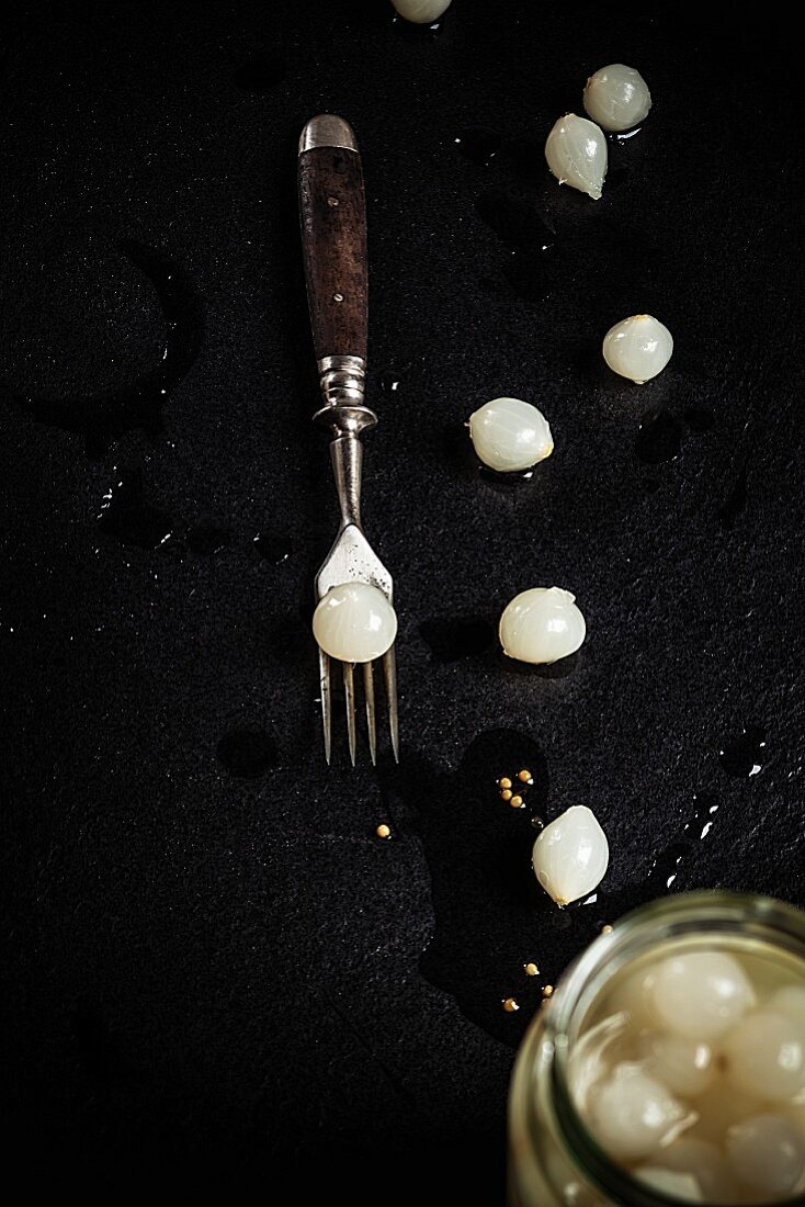 Pickled pearl onions on a black background