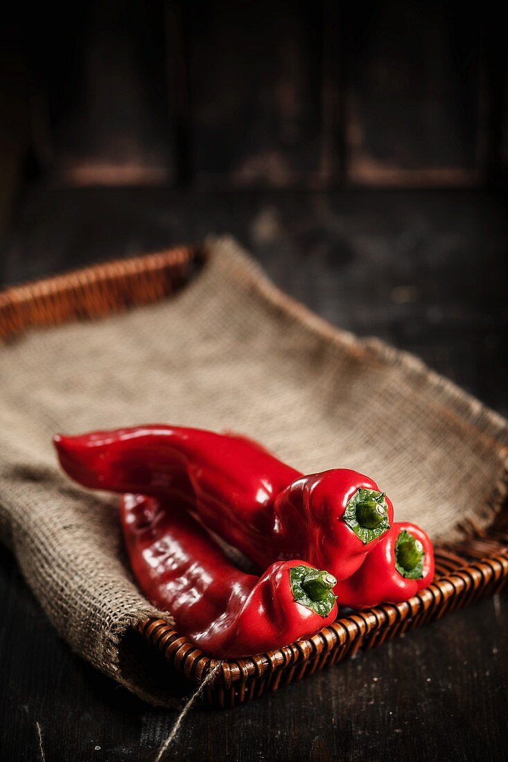 Red pointed peppers on a cork tray