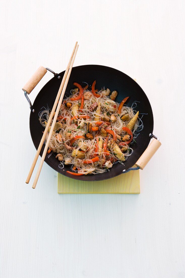 Stir-fried seafood with glass noodles in a wok