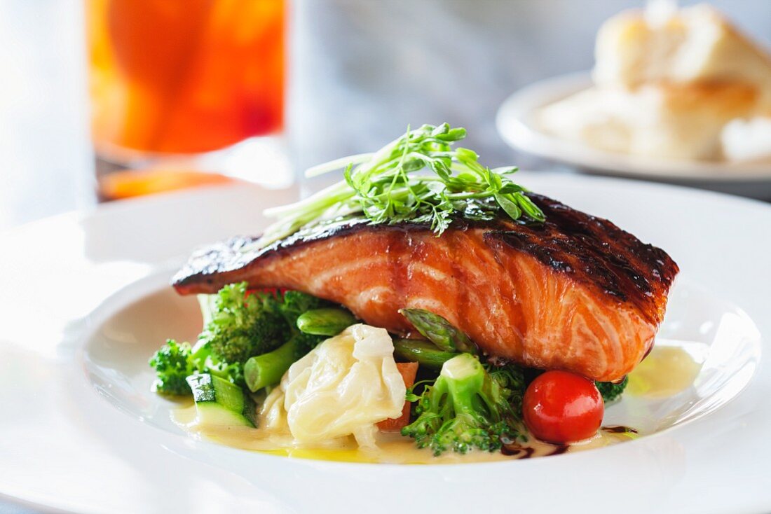 Grilled salmon teriyaki on a bed of vegetables