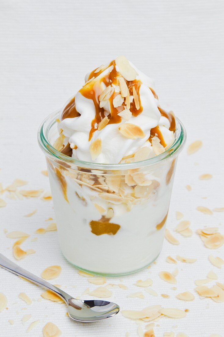 Frozen yogurt with slivered almonds and caramel sauce