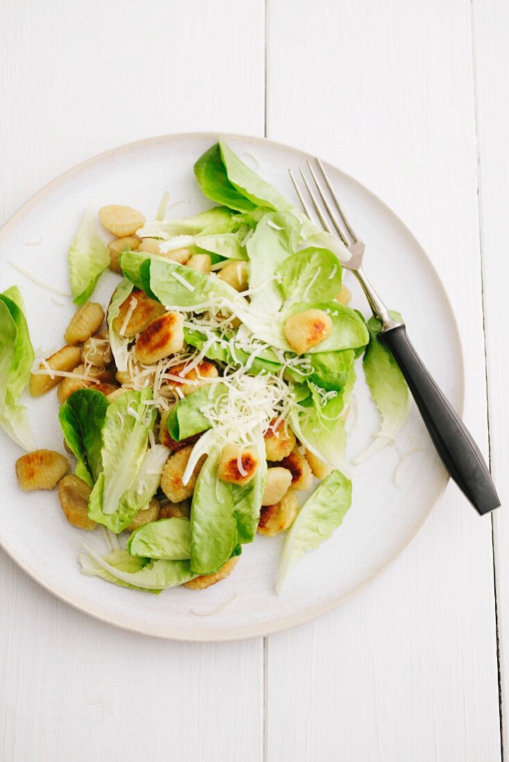 A salad with fried gnocchi