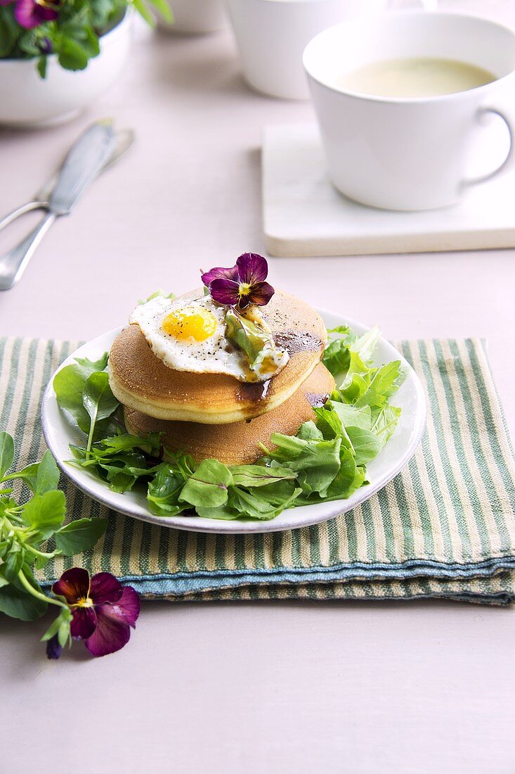Pancakes with lettuce and fried quail's eggs