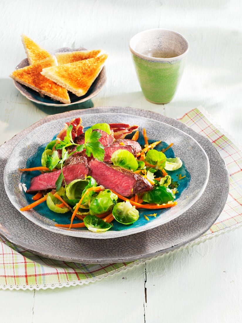 Warm Brussels sprouts salad with roast beef