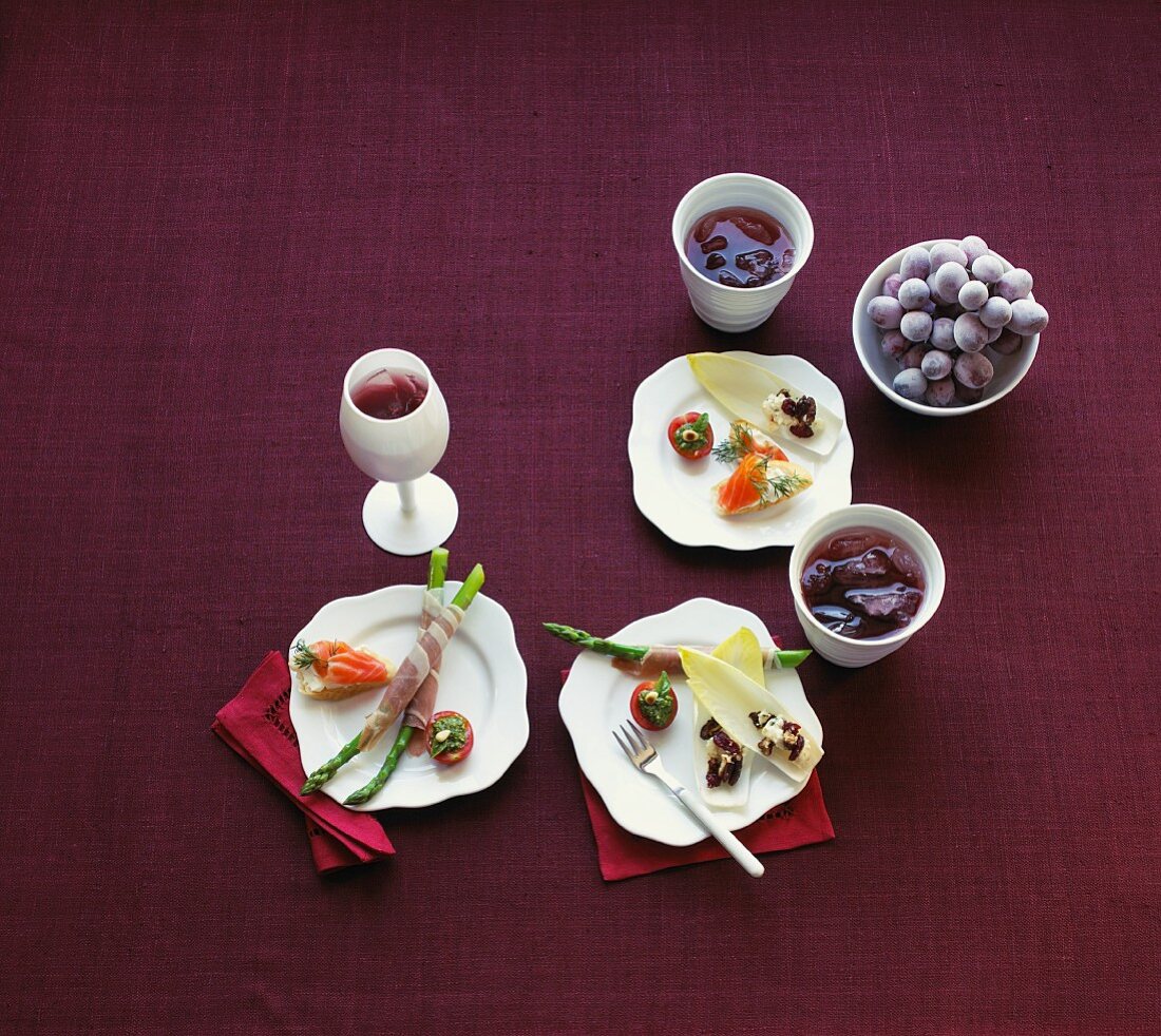Various appetisers featuring grapes and drinks