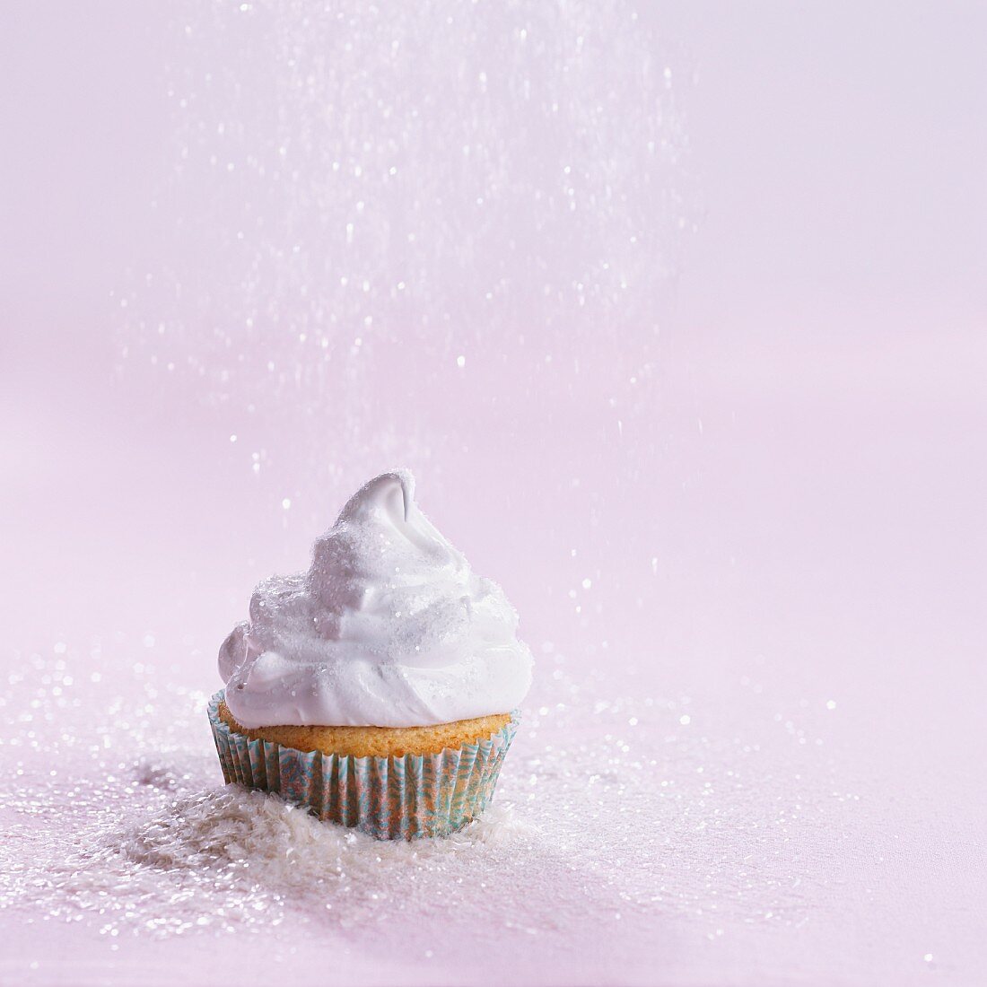 A cupcake sprinkled with grated coconut