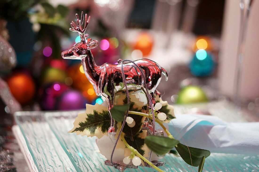 A Christmas decoration with a reindeer figurine on a table