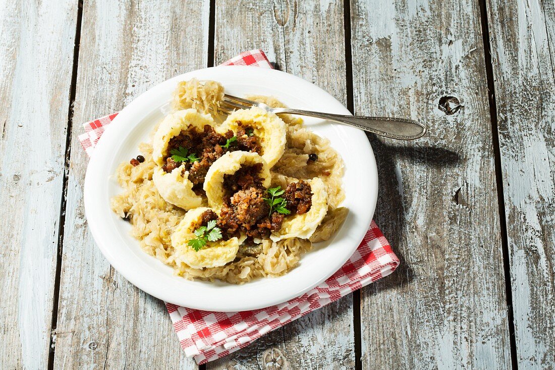 Meat-filled dumplings on a bed of sauerkraut