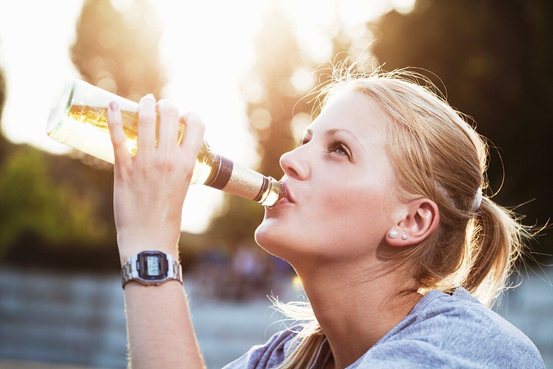 A young woman with a bottle of beer