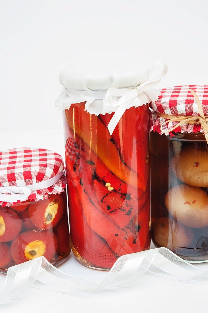 Jars of pickled peppers, chillis and onions as homemade Christmas presents