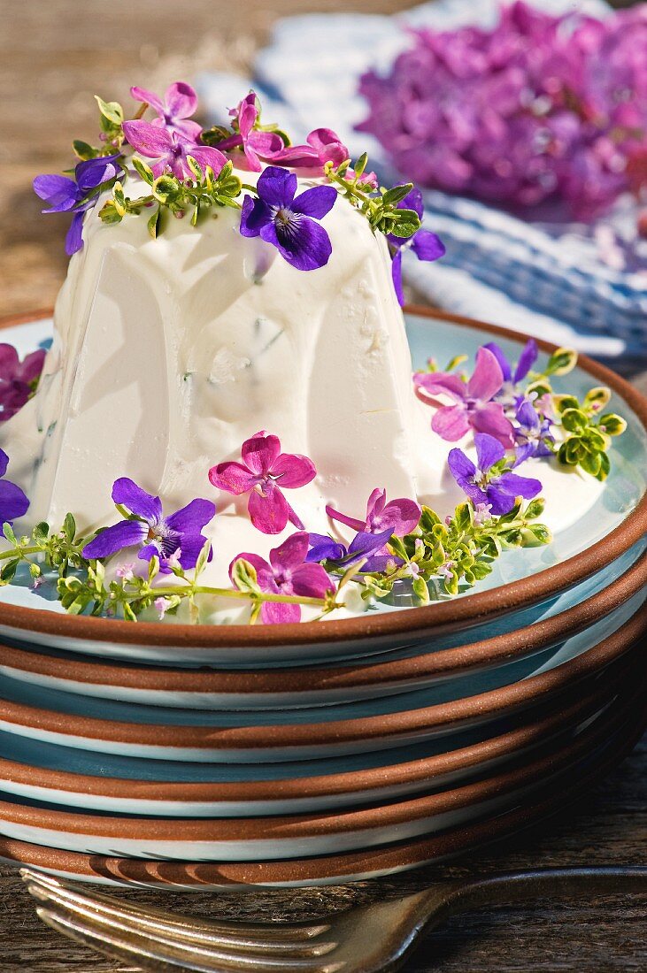Goat's cream cheese with violets and lilac flowers