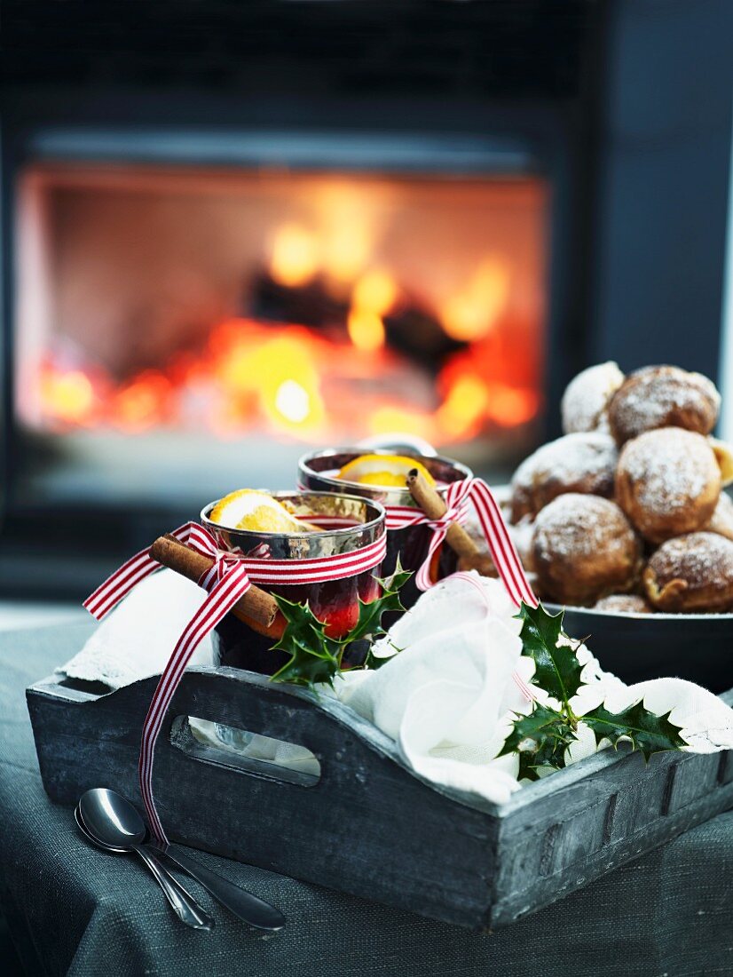Mulled wine and Christmas biscuits in front of a fire place