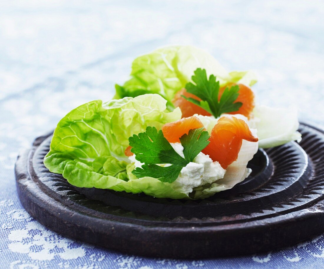 Smoked salmon with cream cheese on a bed of lettuce