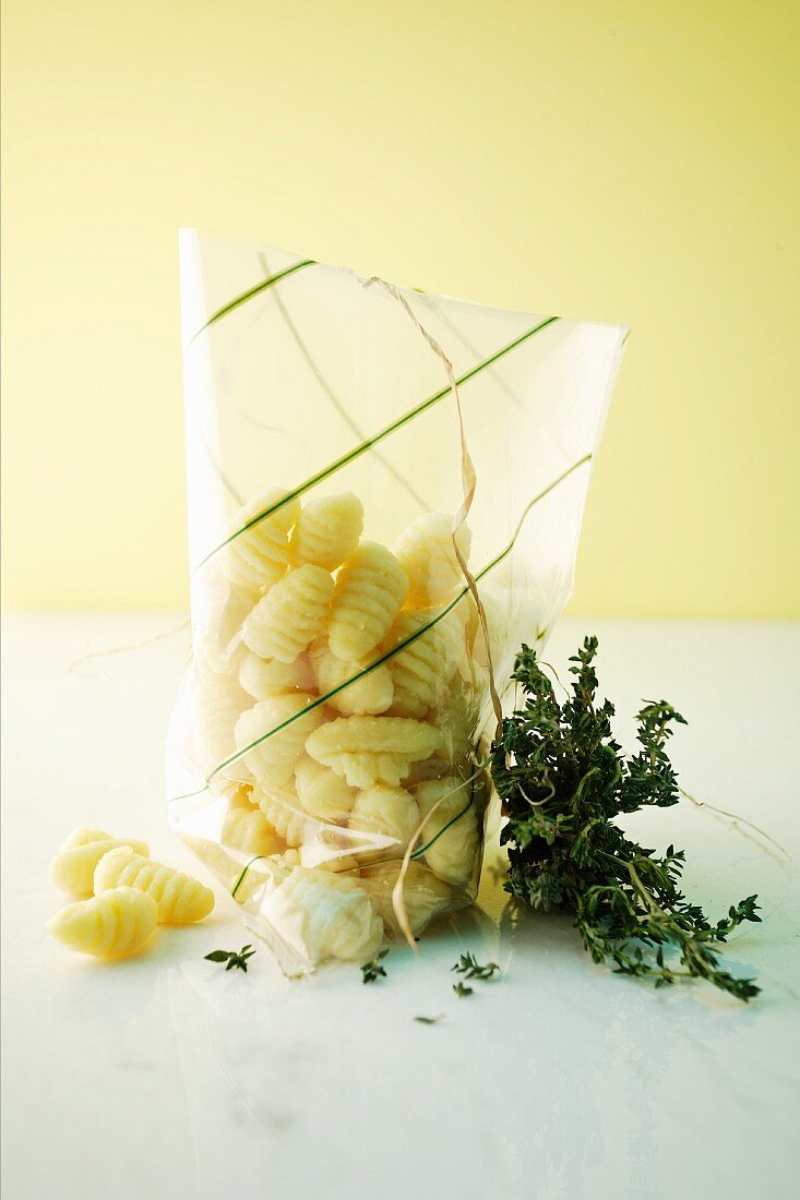 Gnocchi in a plastic bag and fresh thyme