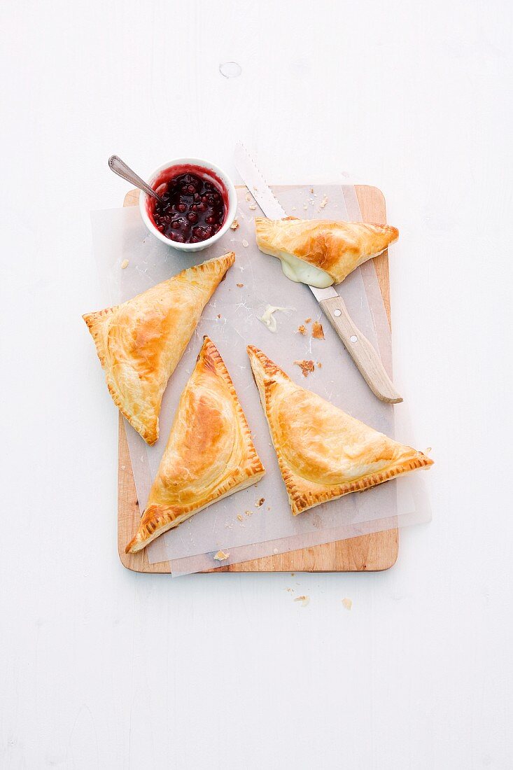 Puff pastry triangles filled with Camembert and chicory served with cranberry jam