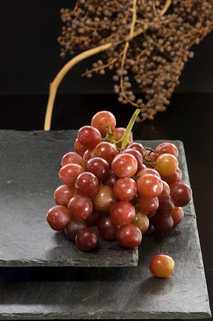 Red grapes on a slate platter