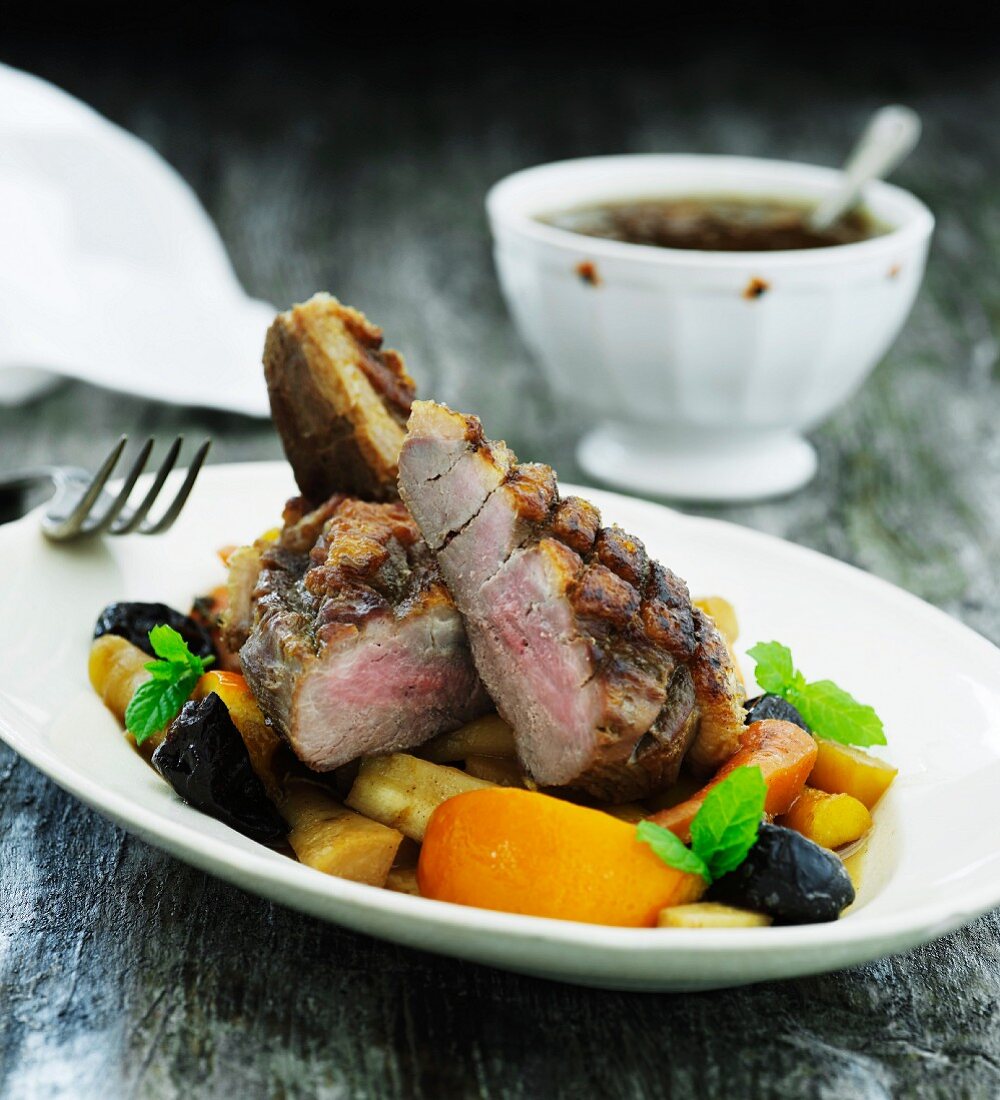 Beef steak with root vegetables and prunes