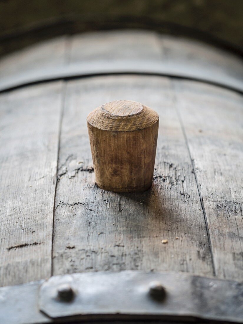 An oak barrel with a wooden bung (cork) in a wine cellars in the Kakheti wine region, Georgia, Caucasus