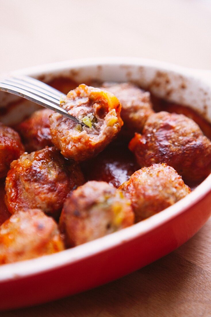 Minced meat and cabbage dumplings in tomato sauce