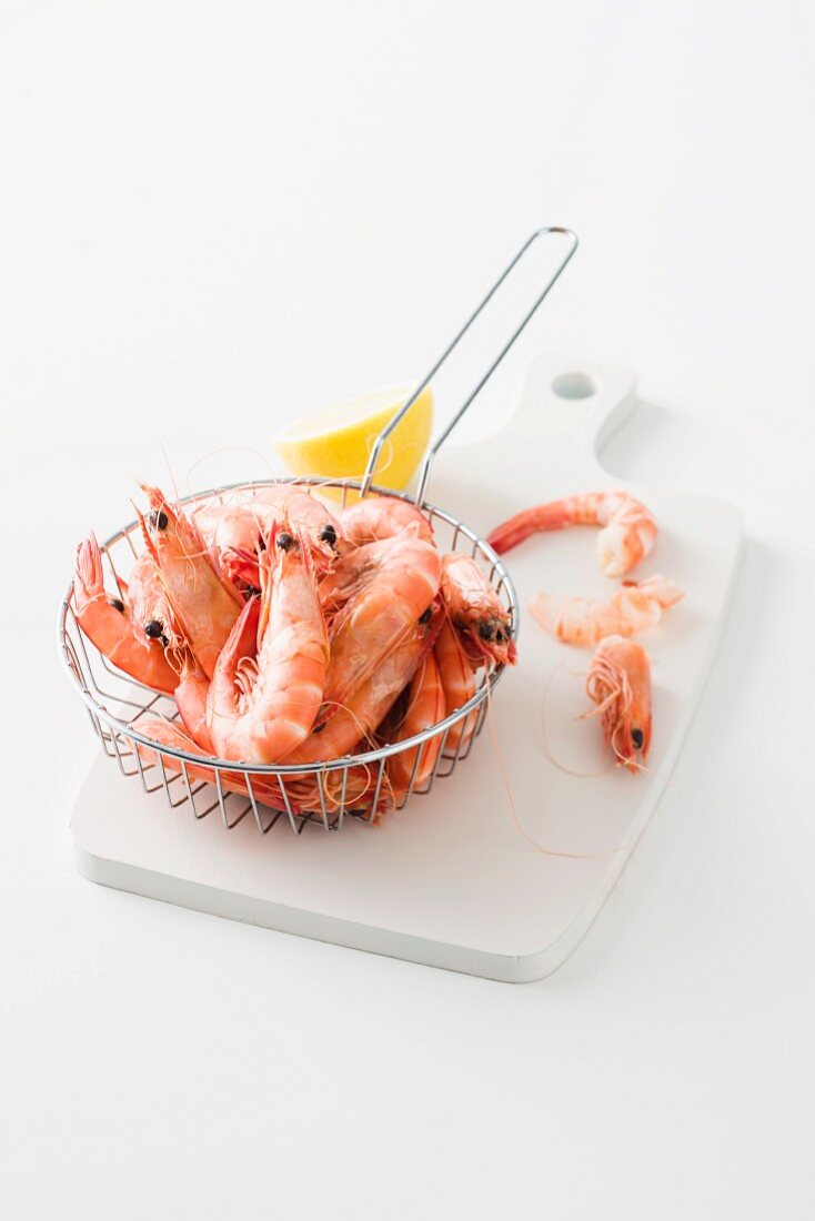 Cooked king prawns in a sieve