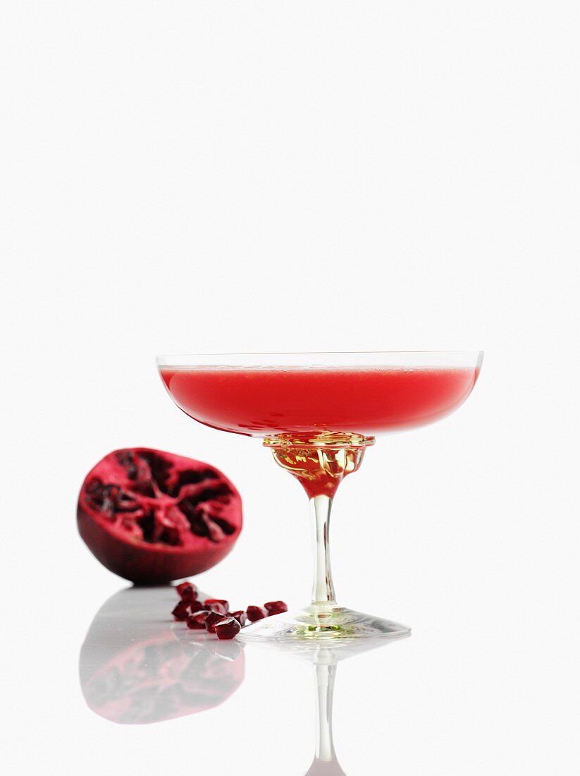 A pomegranate drink in a champagne glass