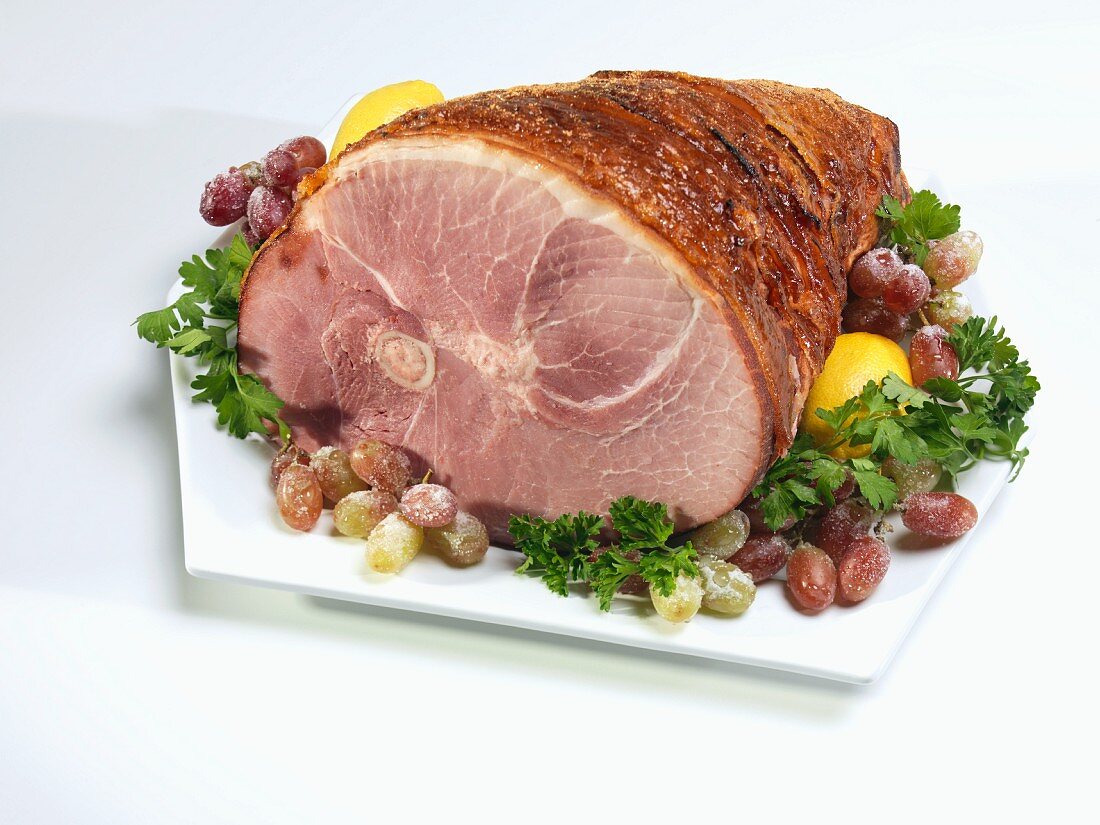 Roast ham with sugared grapes and parsley