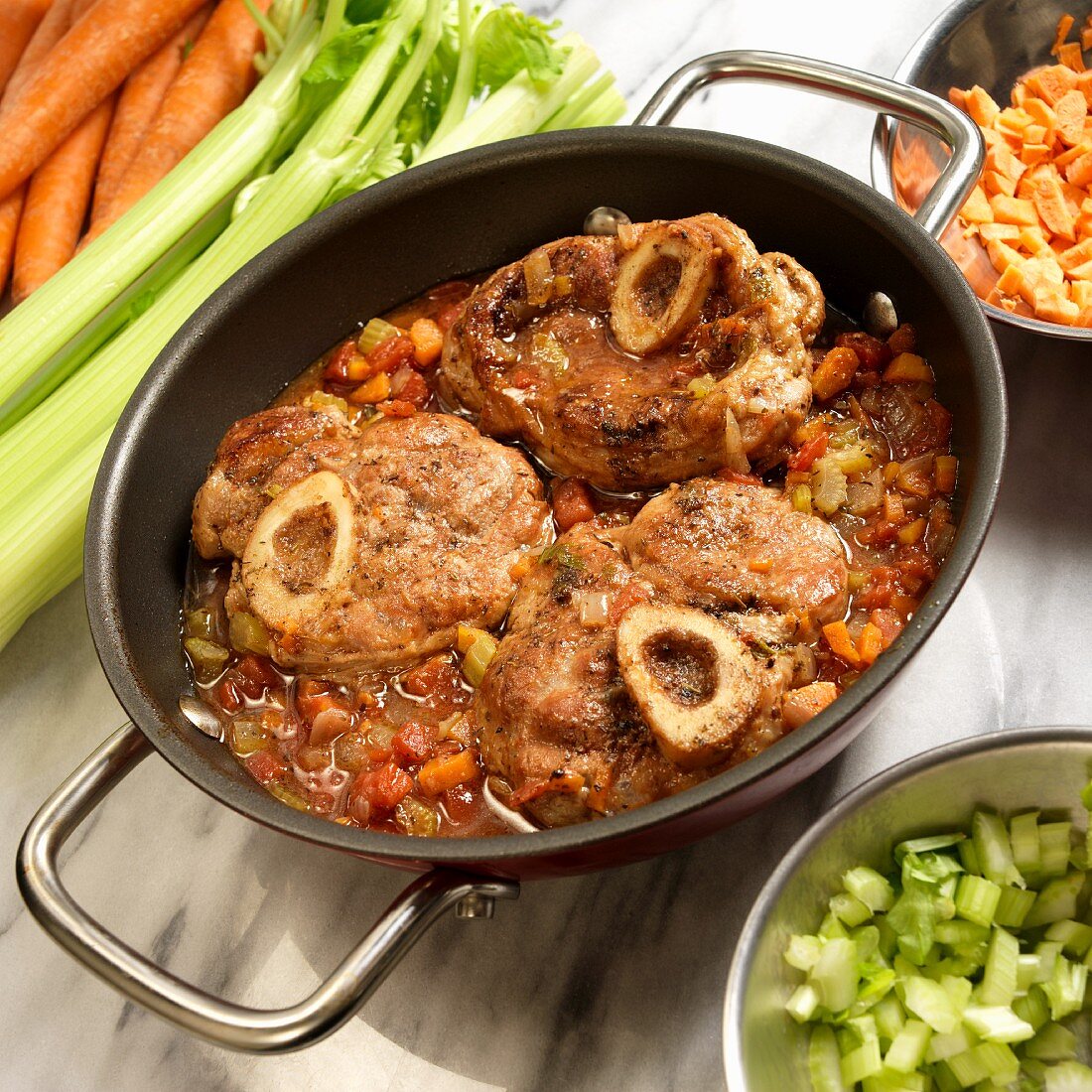 Osso buco with celery and carrots in a stew pot