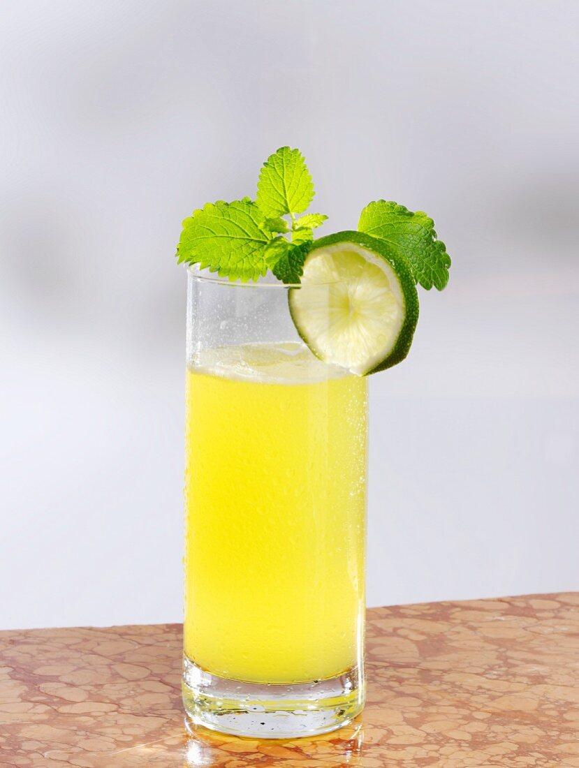 Passion fruit lemonade garnished with lime and mint