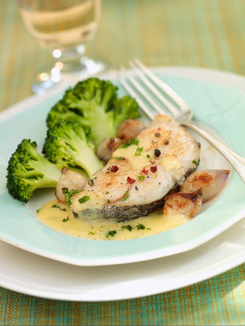 Hake with a butter sauce and broccoli