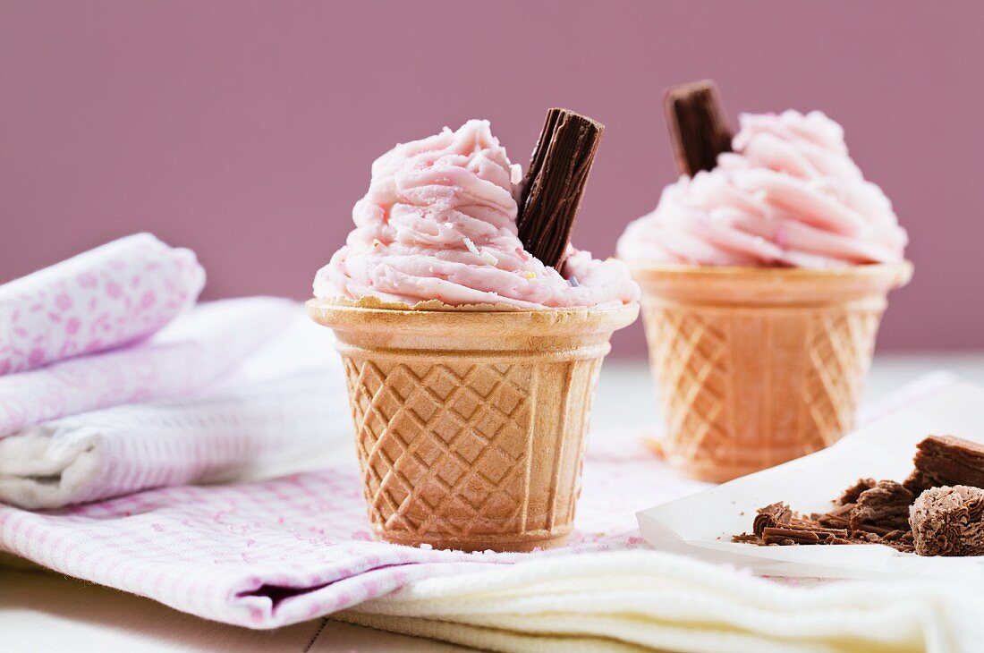 Cupcakes in ice cream cones with strawberry buttercream and chocolate
