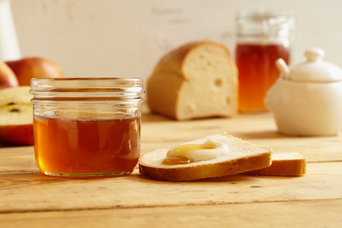 White bread with quark and honey next to a jar of honey