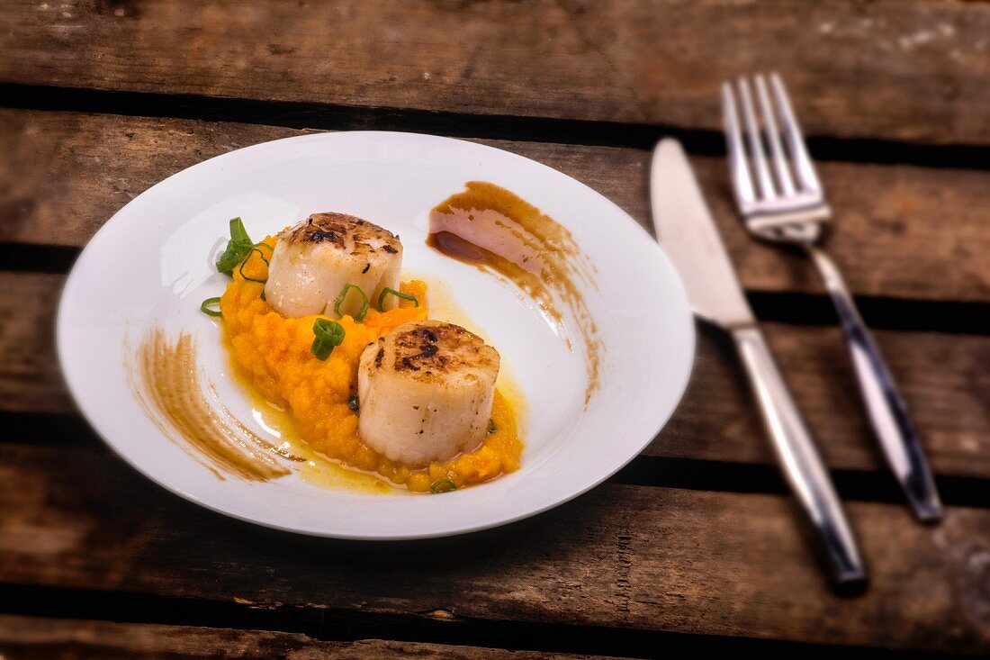 Scallops on a bed of mashed pumpkin and truffles
