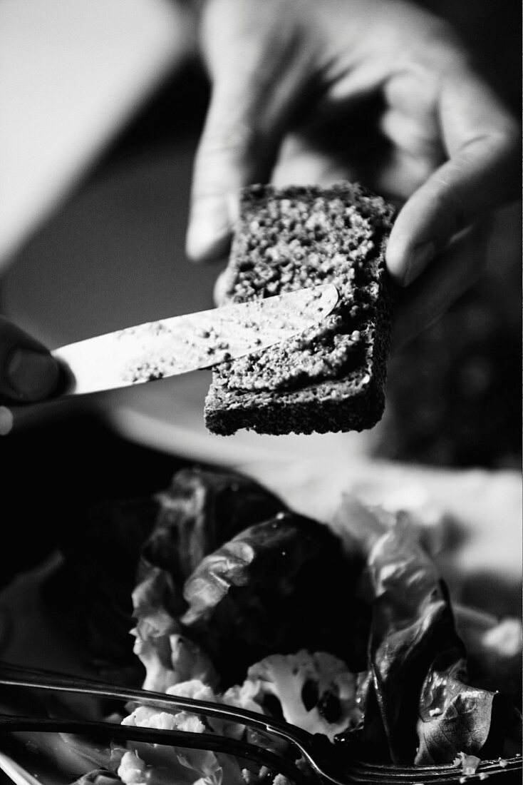 Spread being applied to a slice of wholemeal bread