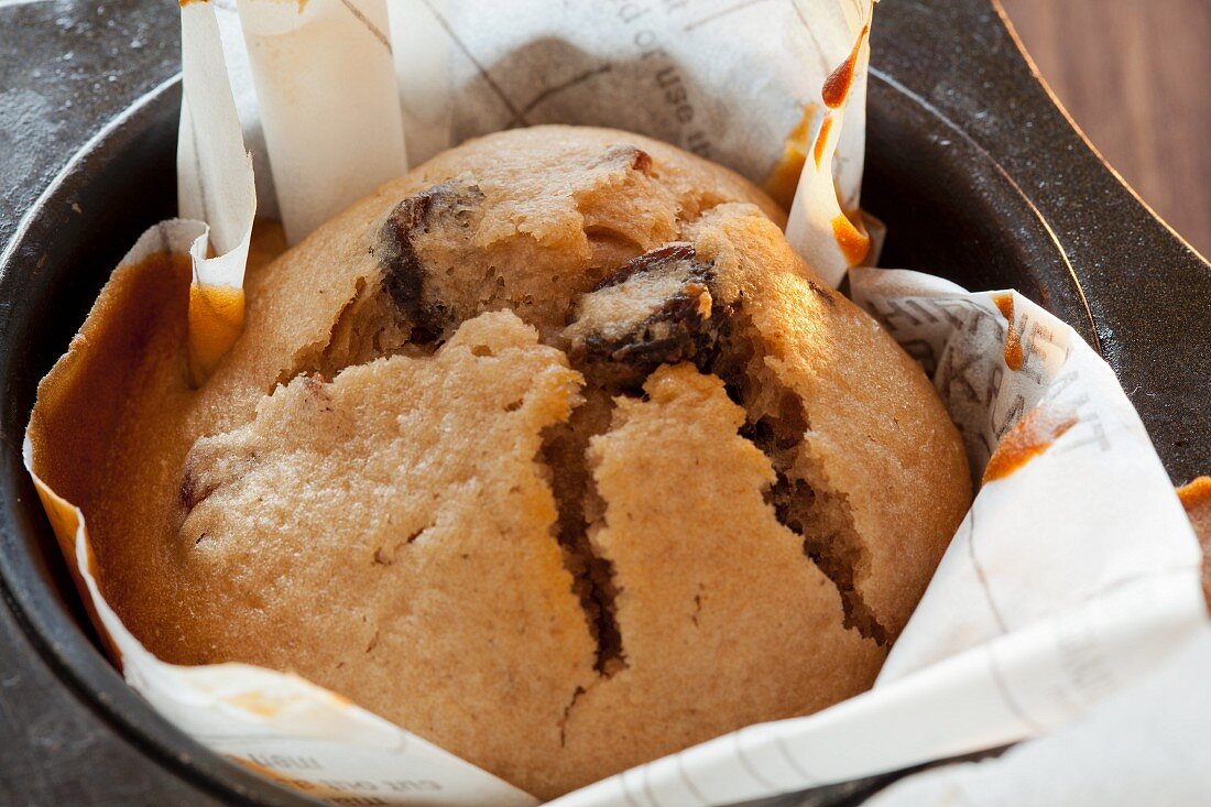 A vanilla and cranberry muffins in a baking tin