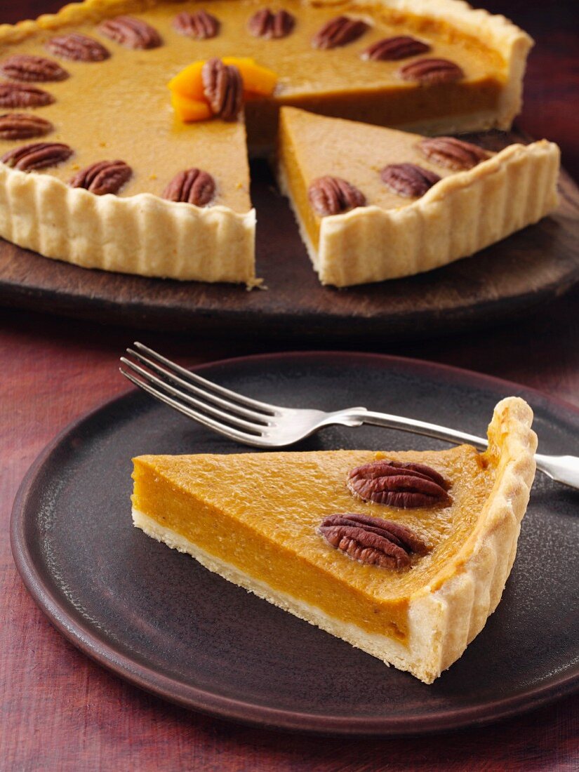 Butternut squash pie with pecan nuts, sliced