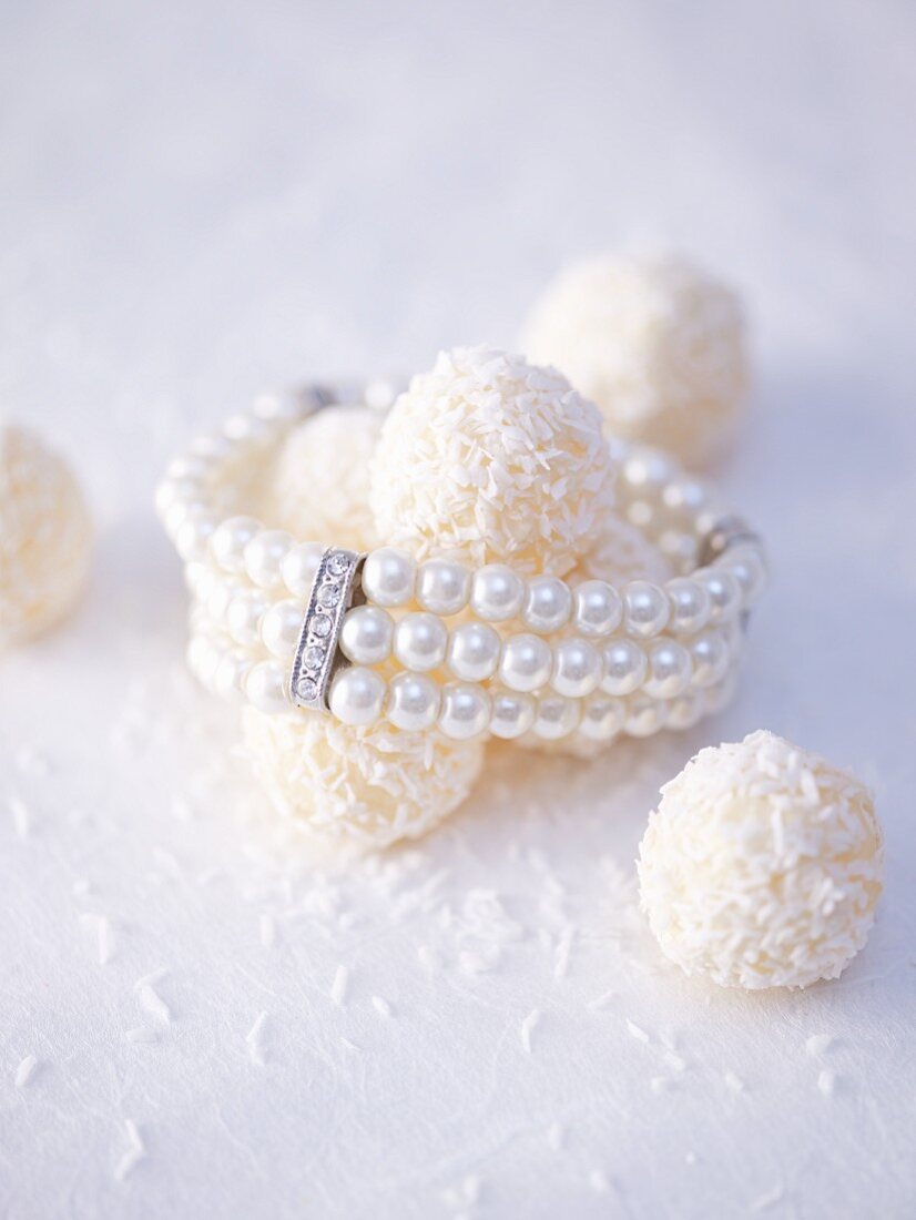 White coconut truffles with a pearl bracelet