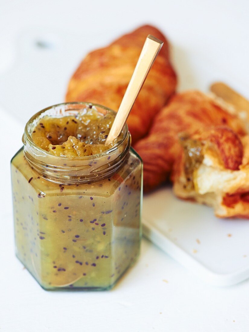 Kiwi jam with vanilla and croissants (close-up)