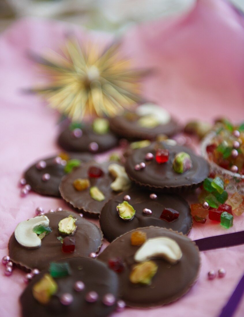 Milk and dark chocolates with nuts, candied fruits and sugar pearls