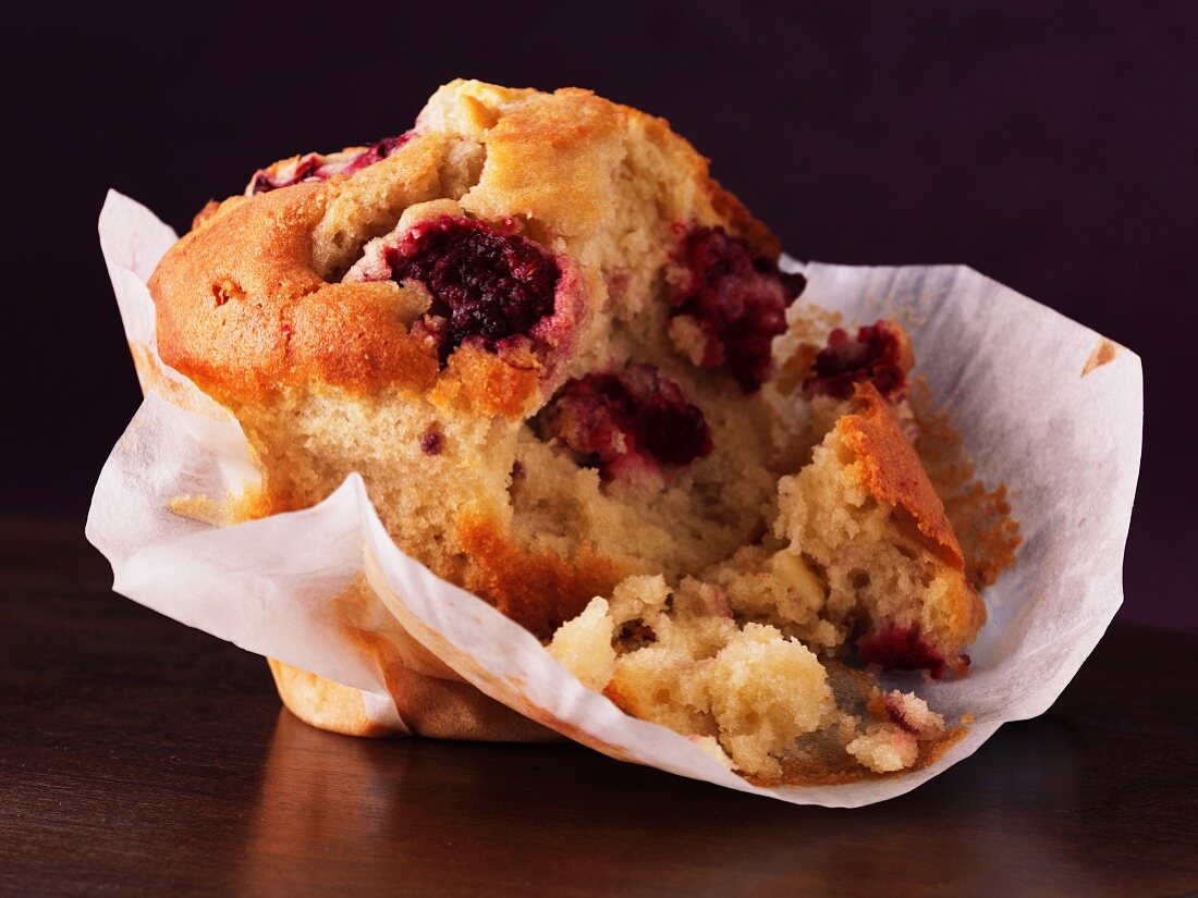 A cranberry muffin with a bite taken out (close-up)
