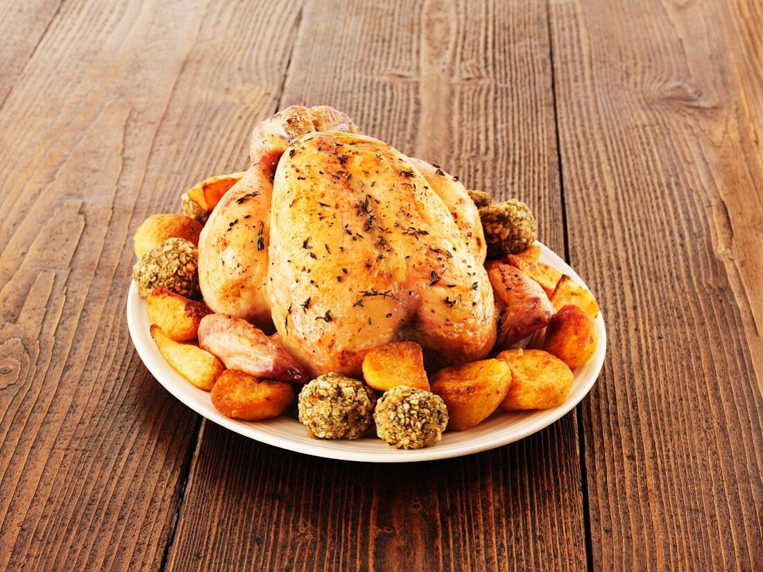 Roast chicken with thyme and oven-roasted vegetables