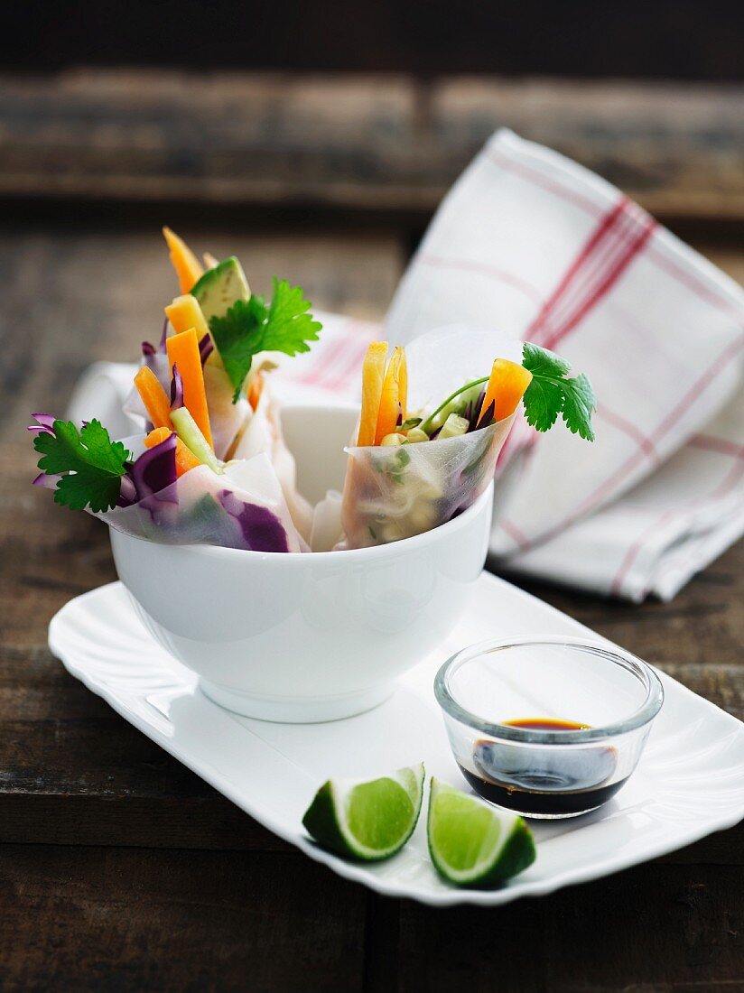 Spring rolls with a vegetable filling, soy sauce and limes