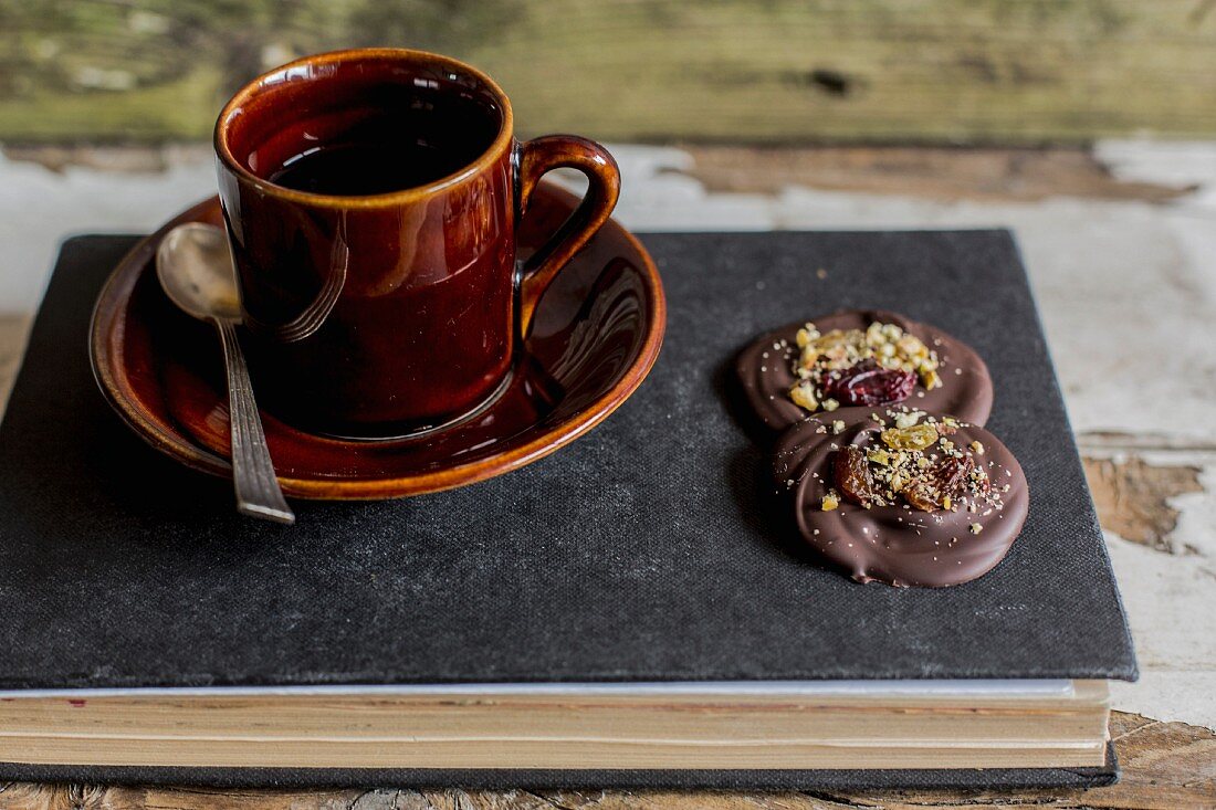 Kaffee und Schokoladenkonfekt auf Buch