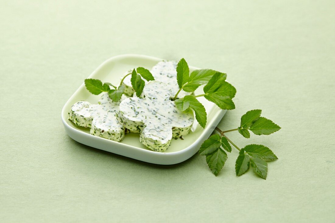 Slices of herb butter on a plate