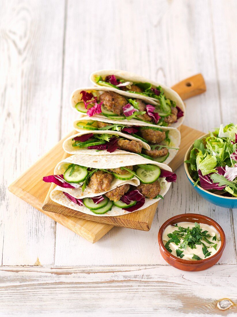 Tortillas filled with meatballs and salad