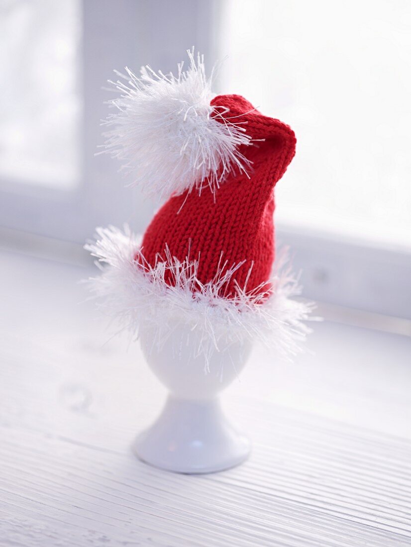 A Father Christmas hat as an egg cosy