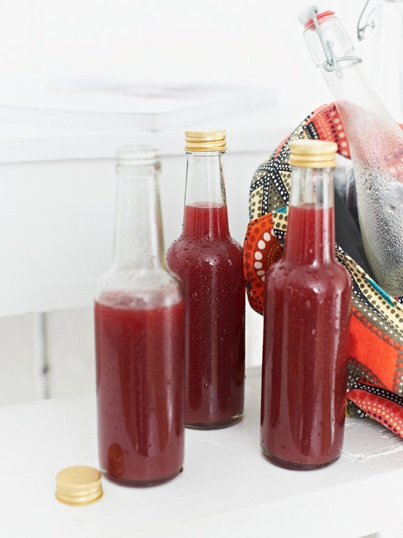 Bottles of home-made grape, apple and mango lemonade